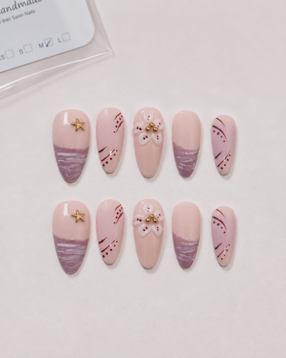 Ten blush and mauve Mauve Starlight almond press-on nails arranged as a complete set.