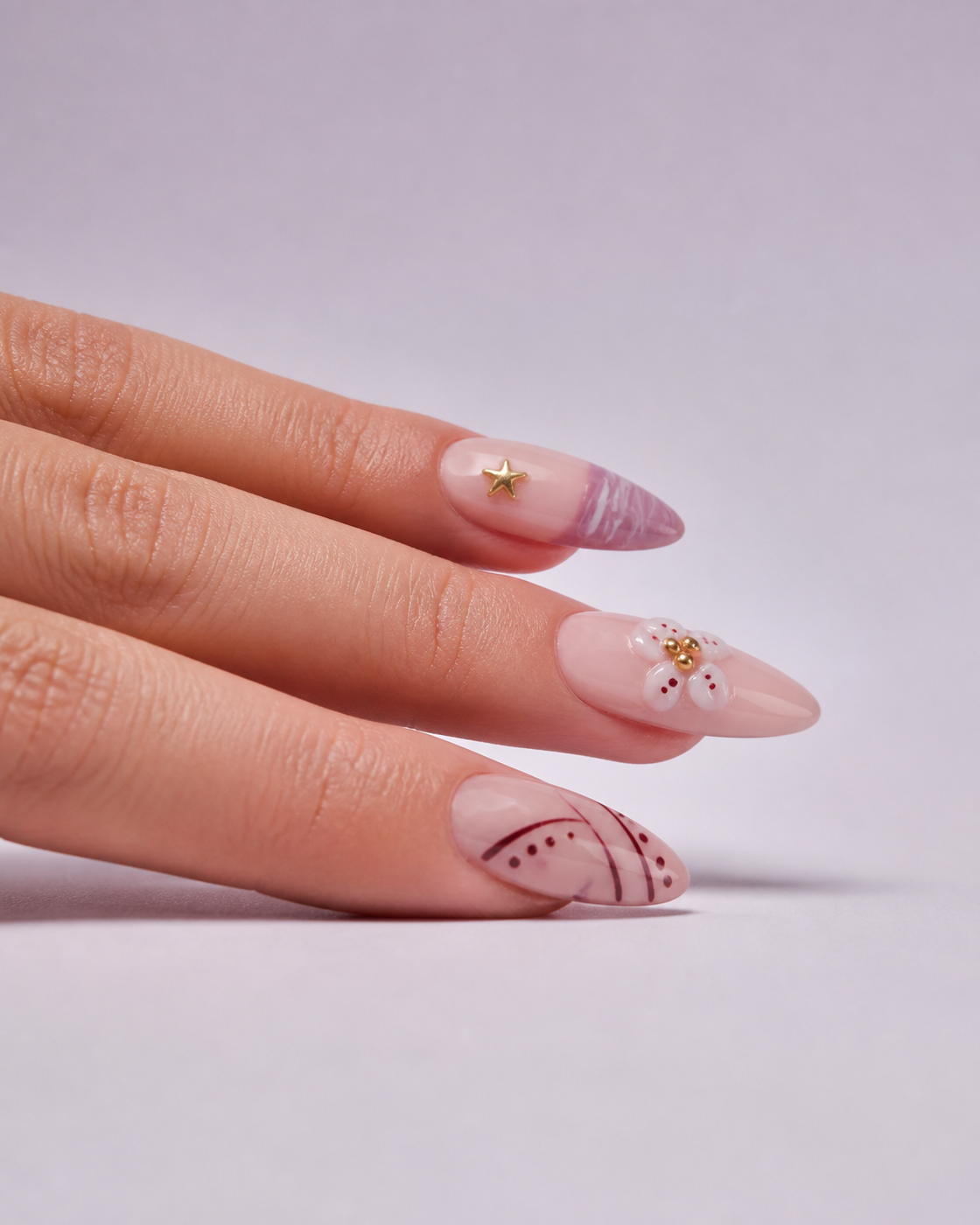 Side profile of Mauve Starlight almond press-on nails worn on a hand.