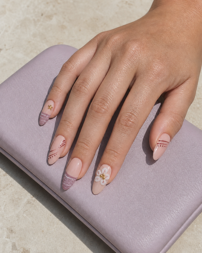 Lifestyle view of a hand wearing Mauve Starlight almond press-on nails.
